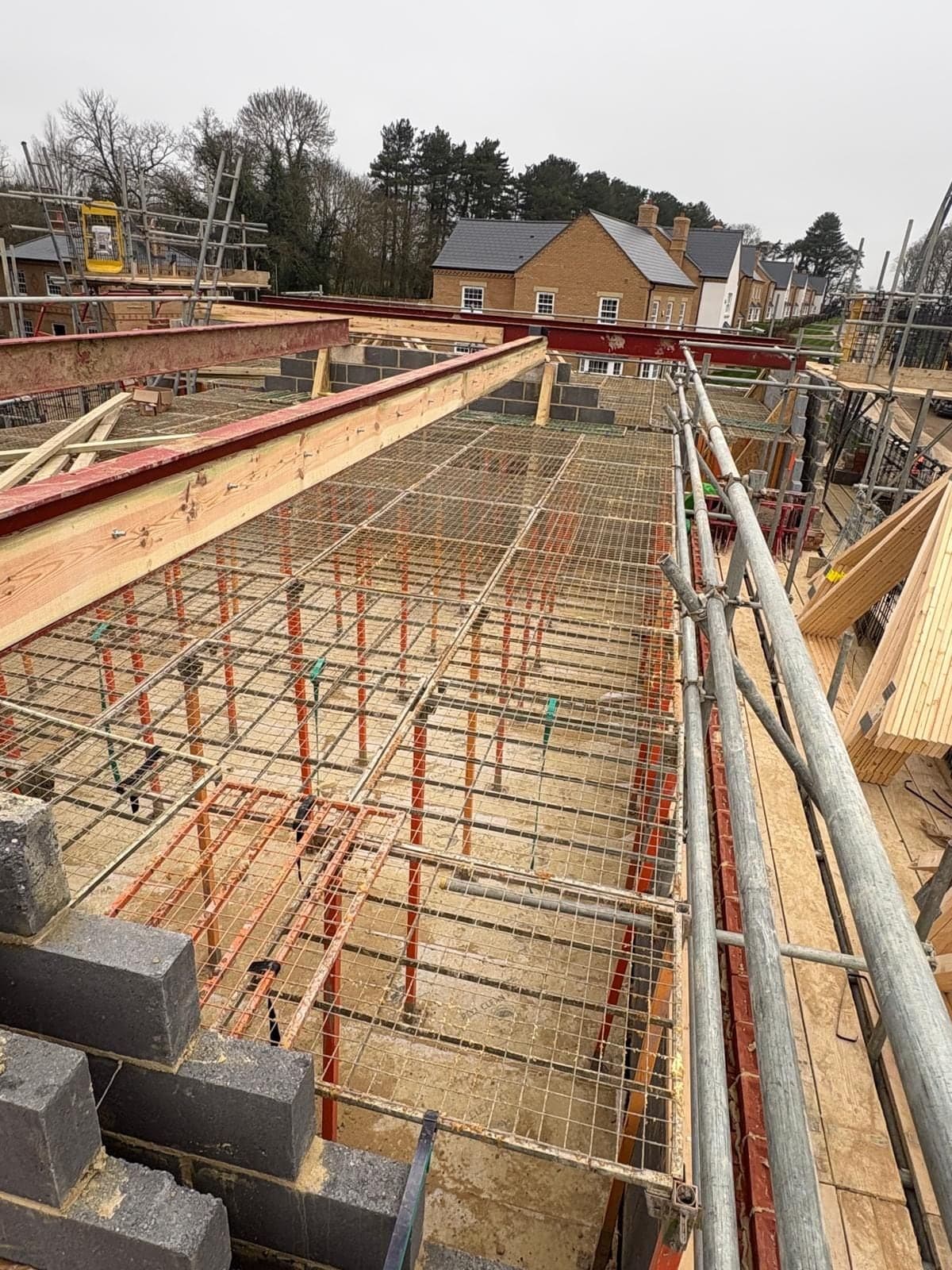 G-Deck Lite steel mesh decking between scaffold runs, new homes beyond
