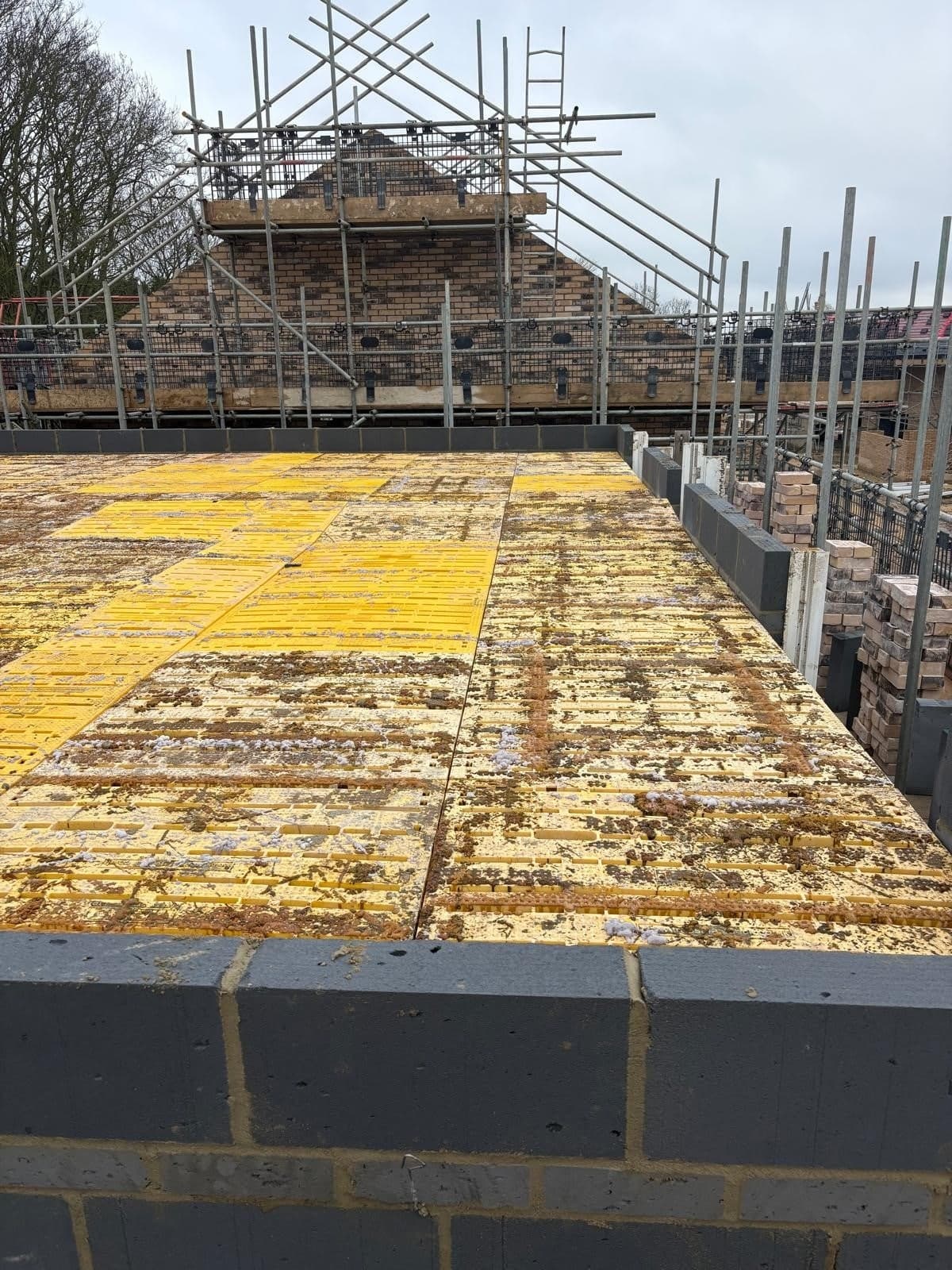 Trad Deck covering the full first floor of a house, scaffold and roof beyond